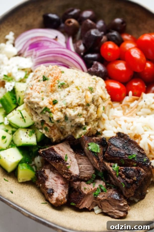 Colorful Beef Shawarma Bowls with Vermicelli Rice Pilaf, showcasing fresh vegetables like cucumbers, tomatoes, and onions, perfect for a balanced and healthy Middle Eastern meal. #shawarma #shawarmabowl #vermicellirice #healthydinner