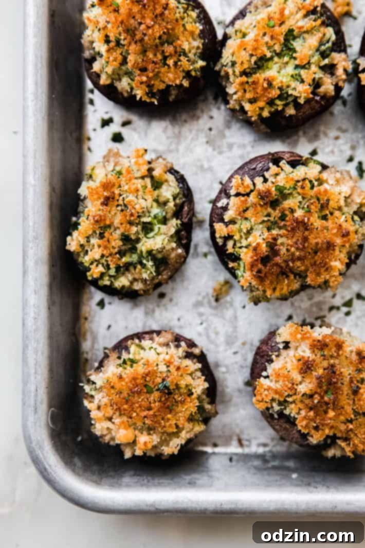 baked cream cheese stuffed mushrooms on baking sheet