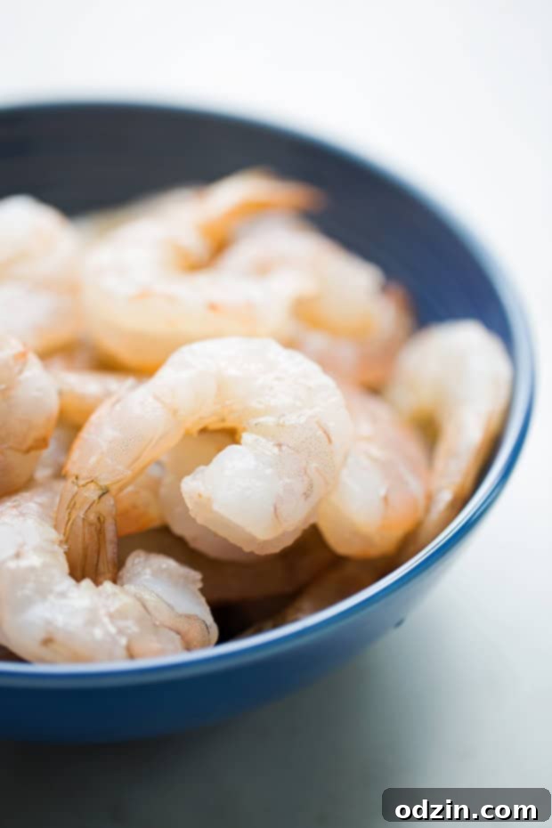 cleaned shrimp in a blue bowl on white marble