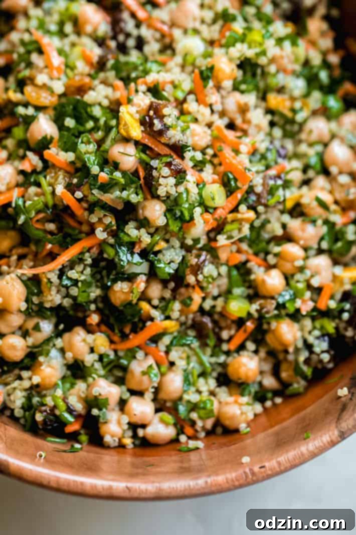Moroccan Energy Quinoa Bowl 5 dates, parsley, scallions, carrots, and chickpeas tossed with quinoa in wooden bowl
