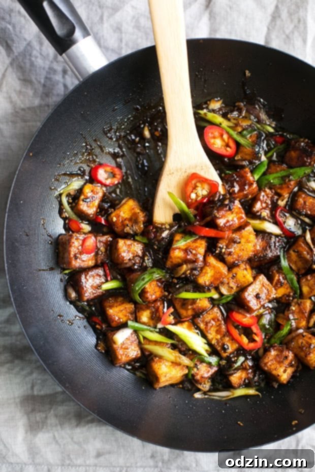 Delicious Black Pepper Tofu Stir Fry - Close-up of saucy, crispy tofu stir-fried with vegetables. A vibrant and easy plant-based meal. #veganstirfry #stirfry #blackpeppertofu #tofu