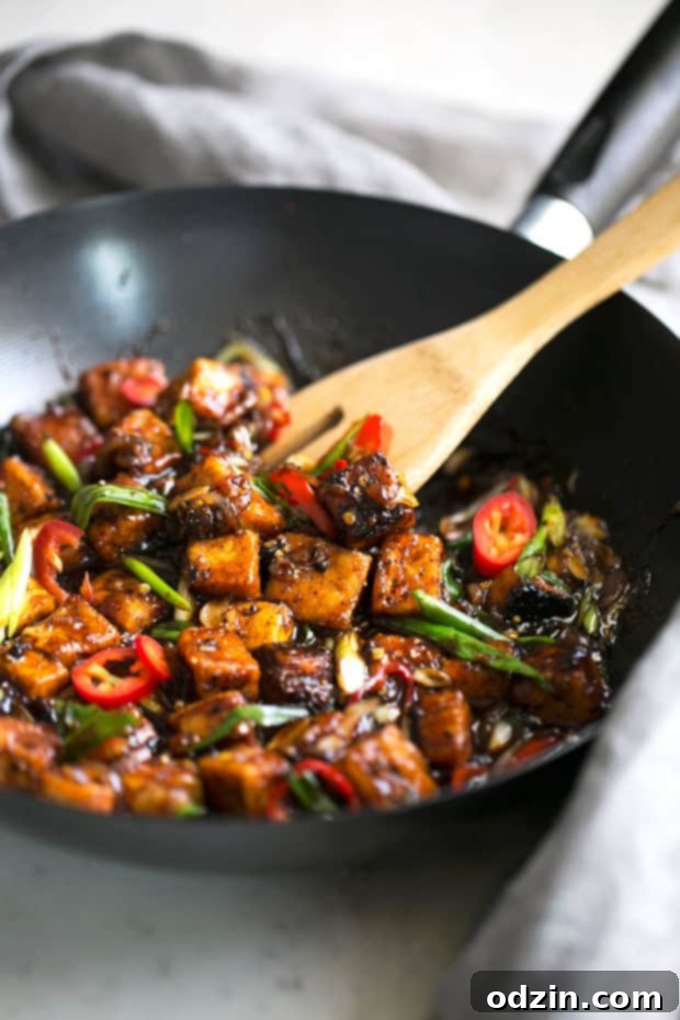 Black Pepper Tofu Stir Fry Served - A serving of crispy black pepper tofu stir fry over white rice, garnished with scallions. Delicious vegan meal prep idea. #veganstirfry #stirfry #blackpeppertofu #tofu