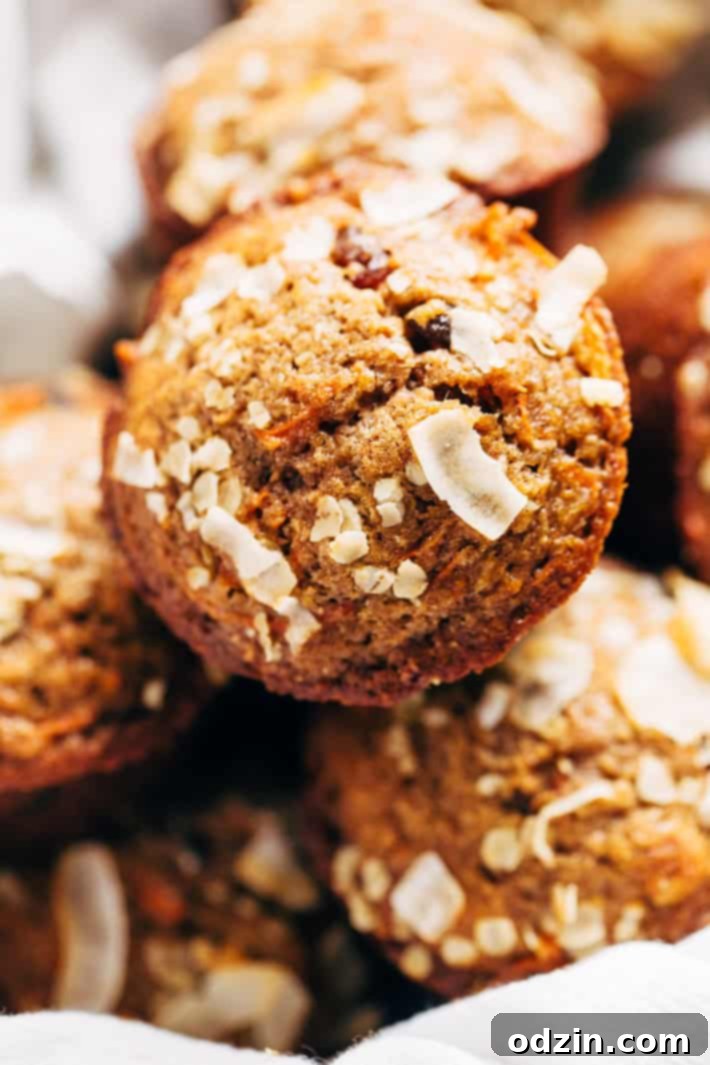 Super Moist and Healthy Carrot Cake Muffins, made with less sugar and packed with Greek yogurt and applesauce for incredible tenderness. A truly healthy treat from Littlespicejar.com