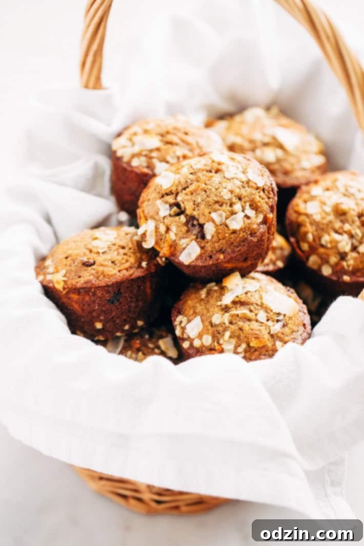 Close-up of Super Moist and Healthy Carrot Cake Muffins, showcasing their tender crumb and delicious add-ins. A perfect breakfast or snack idea from Littlespicejar.com