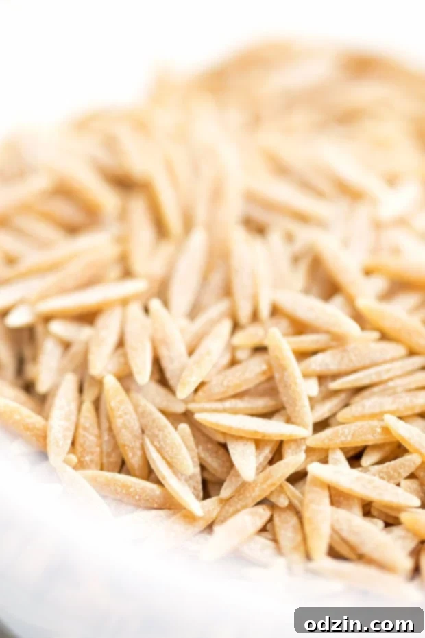 Colorful Mediterranean Tuna Orzo Salad in a bowl with fresh herbs