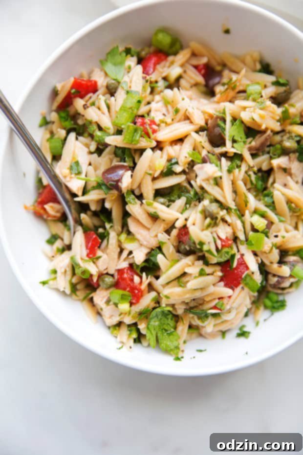 Large bowl of Mediterranean Tuna Orzo Summer Salad ready for serving