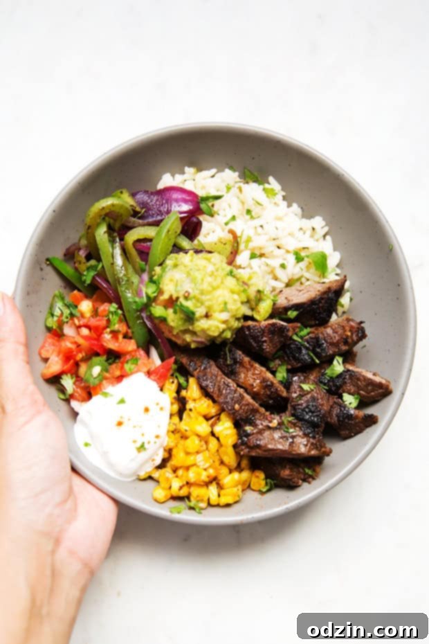Homemade steak fajita bowls with garlic lime rice. These fajita bowls taste even better than the ones at Chipotle! The secret is the homemade marinade for the steak... it is to DIE for! #steakfajita #steakfajitabowls #fajitabowls #bowls | littlespicejar.com Homemade steak fajita bowls with garlic lime rice. These fajita bowls taste even better than the ones at Chipotle! The secret is the homemade marinade for the steak... it is to DIE for! #steakfajita #steakfajitabowls #fajitabowls #bowls | littlespicejar.com