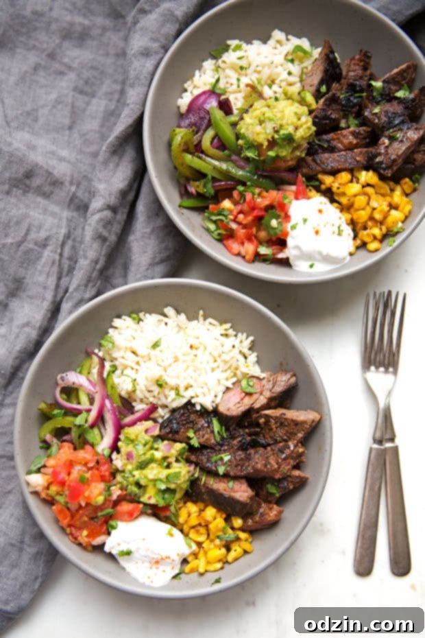 Homemade steak fajita bowls with garlic lime rice. These fajita bowls taste even better than the ones at Chipotle! The secret is the homemade marinade for the steak... it is to DIE for! #steakfajita #steakfajitabowls #fajitabowls #bowls | littlespicejar.com