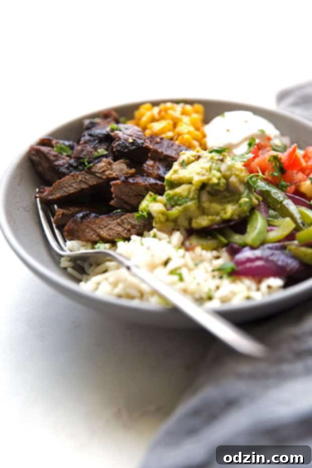Homemade steak fajita bowls with garlic lime rice. These fajita bowls taste even better than the ones at Chipotle! The secret is the homemade marinade for the steak... it is to DIE for! #steakfajita #steakfajitabowls #fajitabowls #bowls | littlespicejar.com Homemade steak fajita bowls with garlic lime rice. These fajita bowls taste even better than the ones at Chipotle! The secret is the homemade marinade for the steak... it is to DIE for! #steakfajita #steakfajitabowls #fajitabowls #bowls | littlespicejar.com