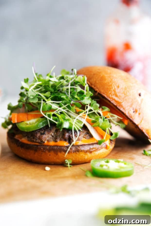 Banh Mi Burgers with Spicy Sriracha Mayo - Homemade burger patties that are juicy and tender topped with all your favorite banh mi fixings! #banhmi #banhmiburger #burgers #pickledveggies #grilling