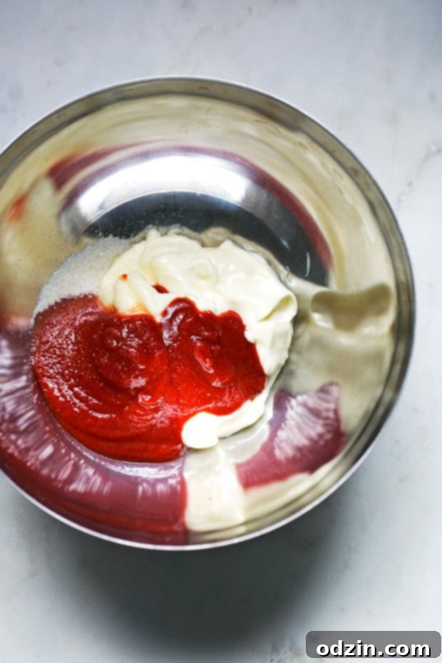 Closeup of perfectly seasoned beef patties ready for grilling, showcasing the savory spice blend on the exterior.
