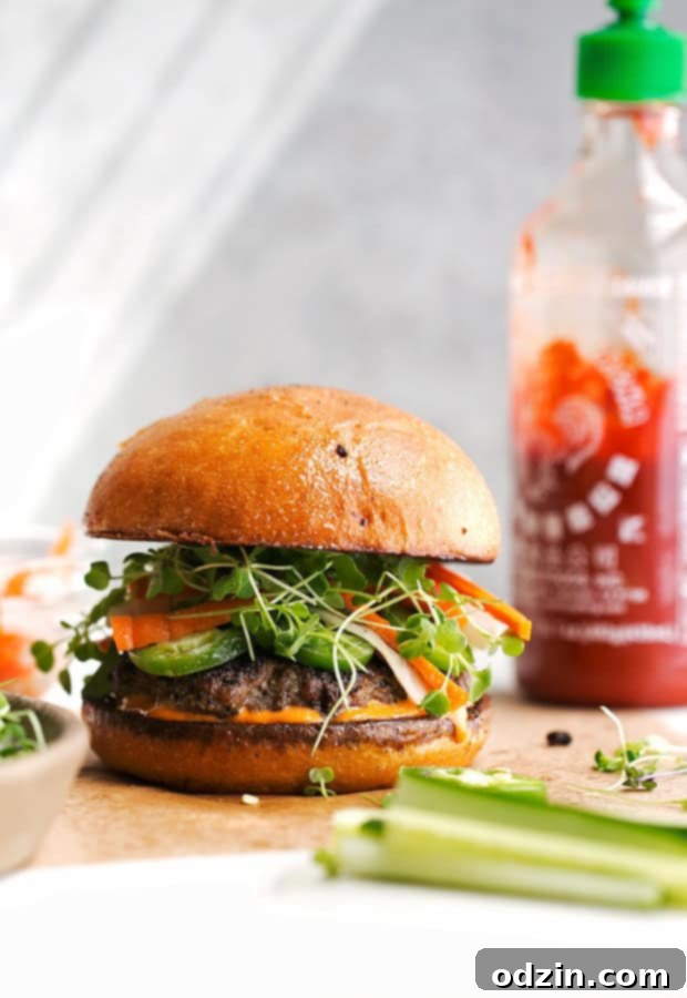 Close-up of a complete Banh Mi Burger, showcasing the vibrant colors and textures of its components, ready to be enjoyed.