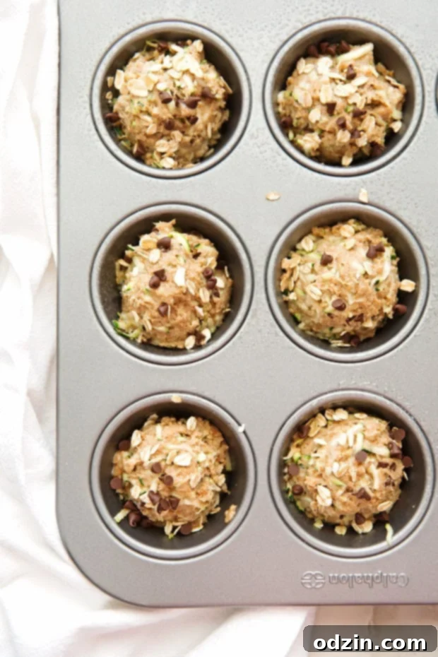 Healthy Zucchini Muffins with Chocolate Chips - Enjoy the goodness of whole wheat and zucchini in every bite. Healthy Zucchini Muffins with Chocolate Chips - Wholesome ingredients make these muffins a guilt-free pleasure.