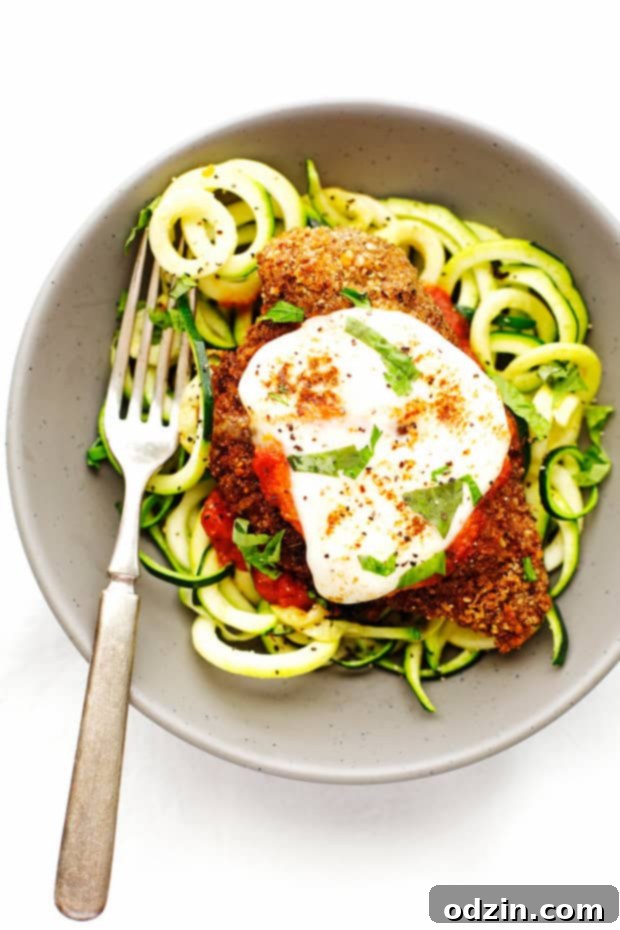 Walnut Crusted Healthy Chicken Parmesan with Zoodles - A healthier take on the chicken parm - we're using walnuts to coat the chicken so it's healthier but still has that crunch! #healthychickenparmesan #walnutcrustedchicken #bakedchicken #chickenparmesan | Littlespicejar.com