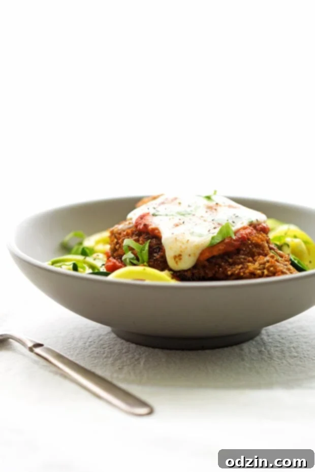 Walnut Crusted Healthy Chicken Parmesan with Zoodles - A healthier take on the chicken parm - we're using walnuts to coat the chicken so it's healthier but still has that crunch! #healthychickenparmesan #walnutcrustedchicken #bakedchicken #chickenparmesan | Littlespicejar.com