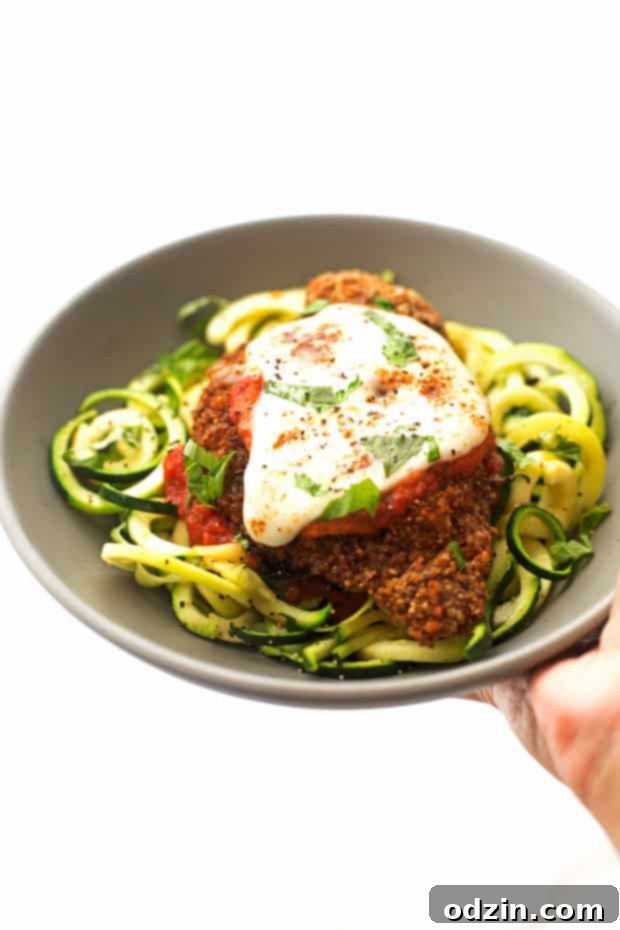 Walnut Crusted Healthy Chicken Parmesan with Zoodles - A healthier take on the chicken parm - we're using walnuts to coat the chicken so it's healthier but still has that crunch! #healthychickenparmesan #walnutcrustedchicken #bakedchicken #chickenparmesan | Littlespicejar.com