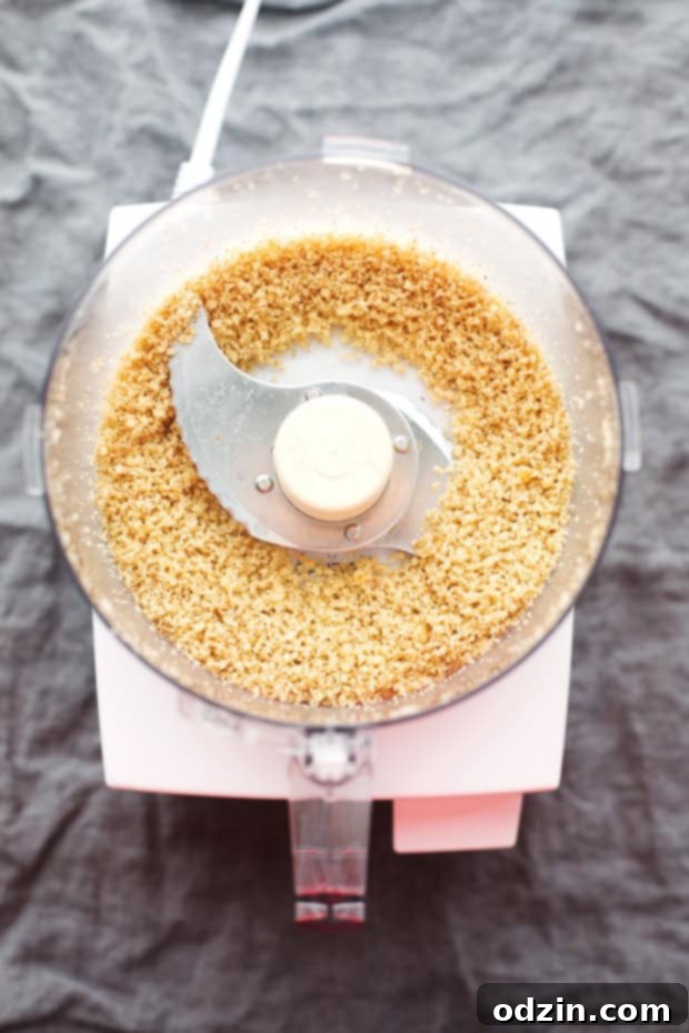 Walnut Crusted Healthy Chicken Parmesan with Zoodles - A healthier take on the chicken parm - we're using walnuts to coat the chicken so it's healthier but still has that crunch! #healthychickenparmesan #walnutcrustedchicken #bakedchicken #chickenparmesan | Littlespicejar.com