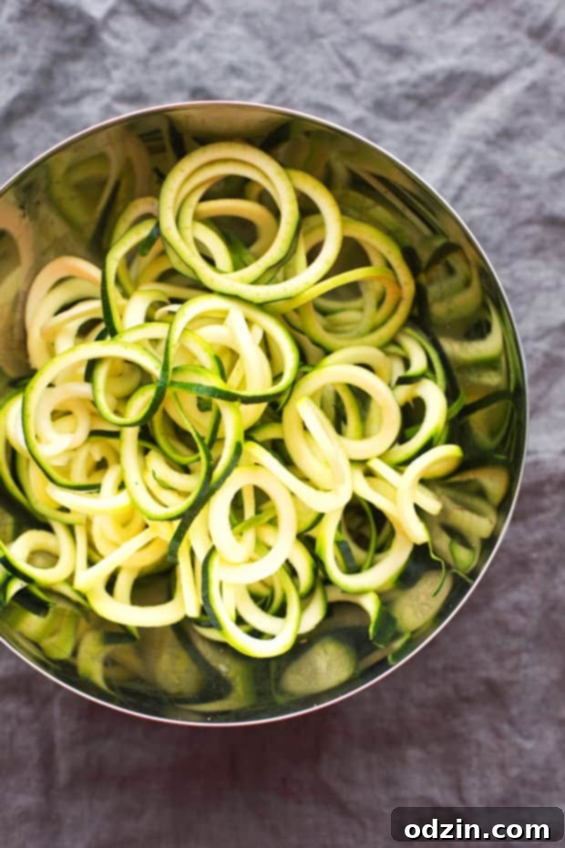 Walnut Crusted Healthy Chicken Parmesan with Zoodles - A healthier take on the chicken parm - we're using walnuts to coat the chicken so it's healthier but still has that crunch! #healthychickenparmesan #walnutcrustedchicken #bakedchicken #chickenparmesan | Littlespicejar.com