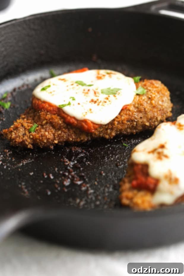 Walnut Crusted Healthy Chicken Parmesan with Zoodles - A healthier take on the chicken parm - we're using walnuts to coat the chicken so it's healthier but still has that crunch! #healthychickenparmesan #walnutcrustedchicken #bakedchicken #chickenparmesan | Littlespicejar.com