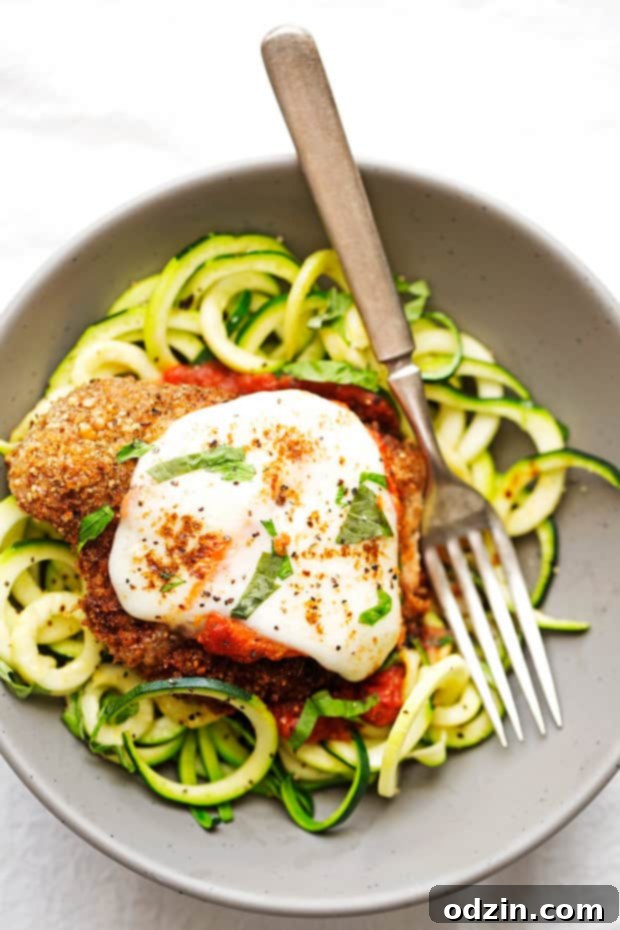 Walnut Crusted Healthy Chicken Parmesan with Zoodles - A healthier take on the chicken parm - we're using walnuts to coat the chicken so it's healthier but still has that crunch! #healthychickenparmesan #walnutcrustedchicken #bakedchicken #chickenparmesan | Littlespicejar.com