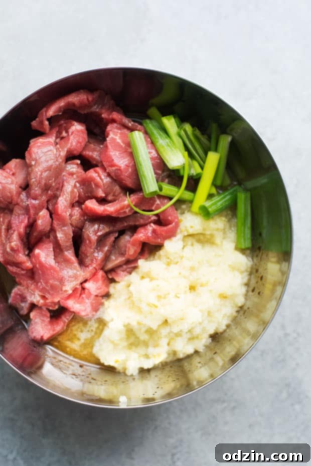 Korean BBQ Bowls with Garlic Scented Rice - Warm, comforting bowls with marinated steak, garlic rice, and a pickled cucumber salad. It's seriously amazing! #koreanbbqbowls #bowls #garlicrice | Littlespicejar.com