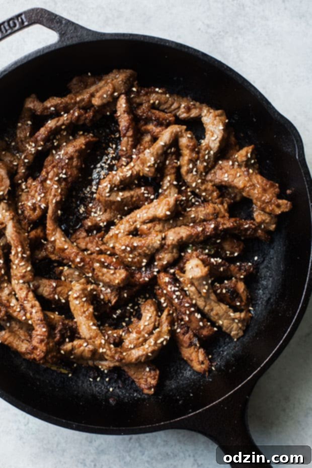 Korean BBQ Bowls with Garlic Scented Rice - Warm, comforting bowls with marinated steak, garlic rice, and a pickled cucumber salad. It's seriously amazing! #koreanbbqbowls #bowls #garlicrice | Littlespicejar.com