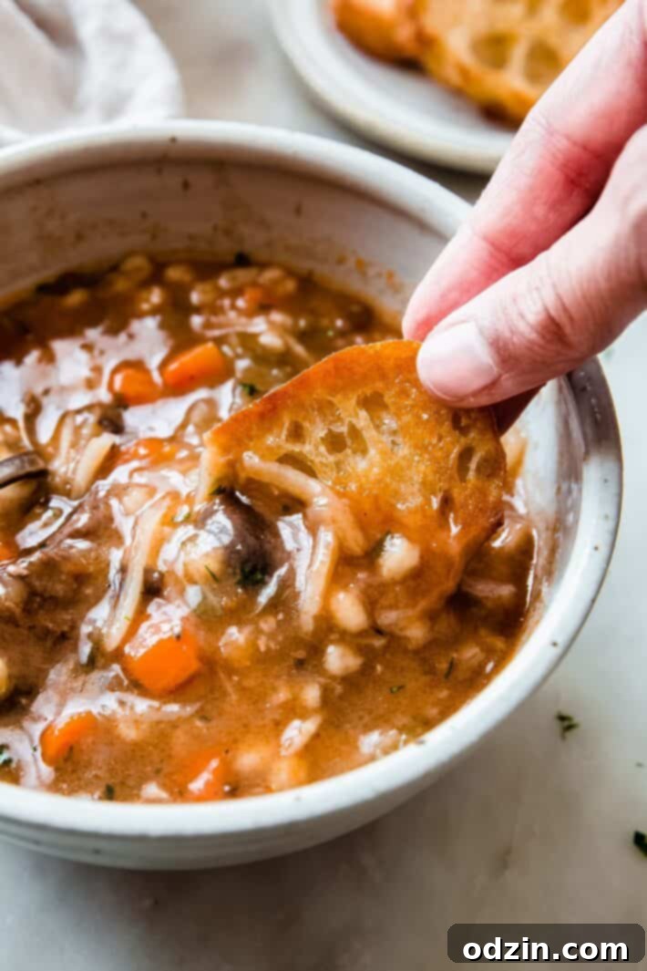 bread being dipped into soup