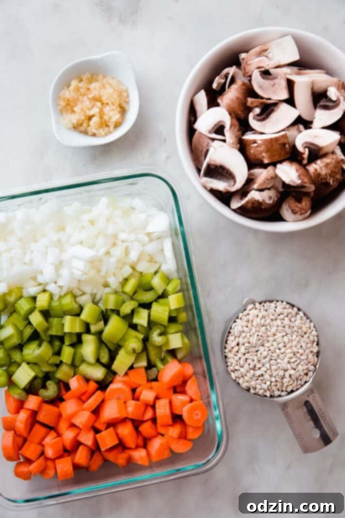 veggies in containers with pearl barley and pressed garlic on white marble