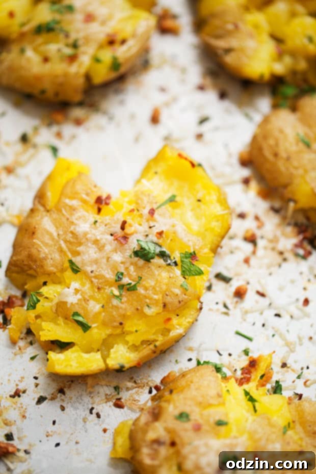 Parmesan Garlic Smashed Potatoes - an easy side dish or the perfect snack for football season! #smashedpotatoes #garlicsmashedpotatoes #potatoskins | Littlespicejar.com