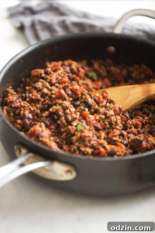 The BEST Cheesy Chili Dip - made with a homemade taco seasoning and NO Velveeta - just simple homemade cheese sauce! So good! #chilicheesedip #cheesychilidip #chilidip | Littlespicejar.com