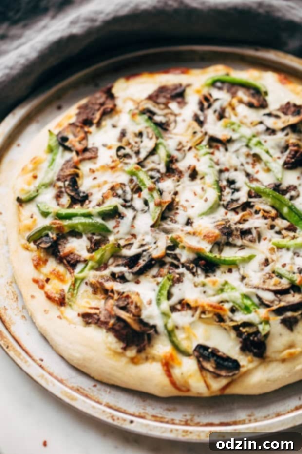 Philly Cheese Steak Pizza with golden crust, melted cheese, and fresh toppings.
