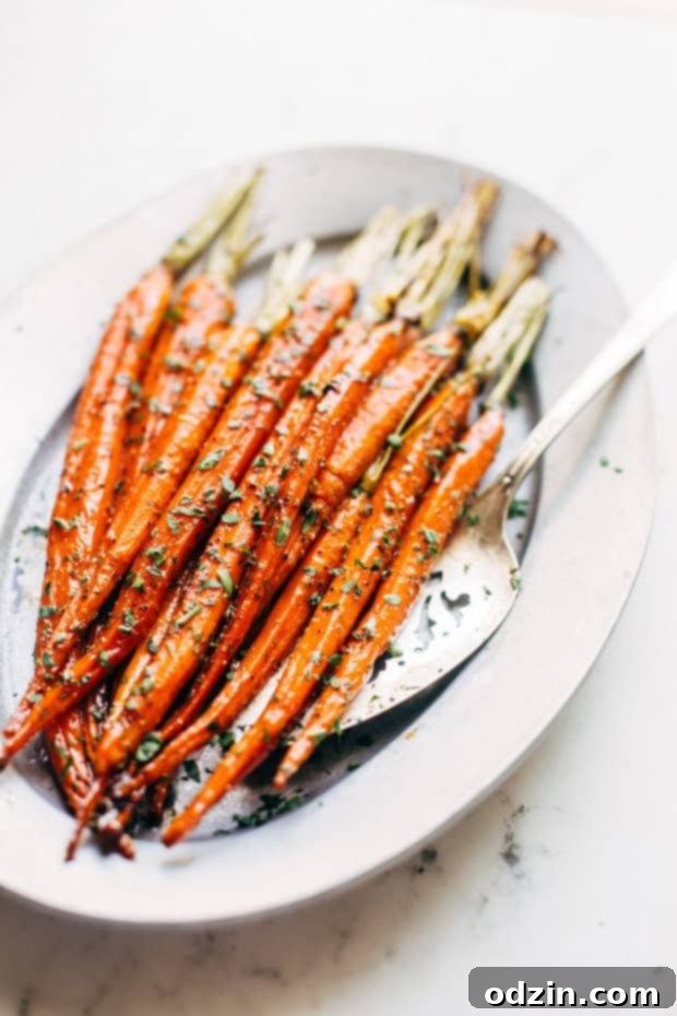 Close-up of brown butter honey glazed carrots served in a bowl, garnished with fresh parsley, ready to be enjoyed.