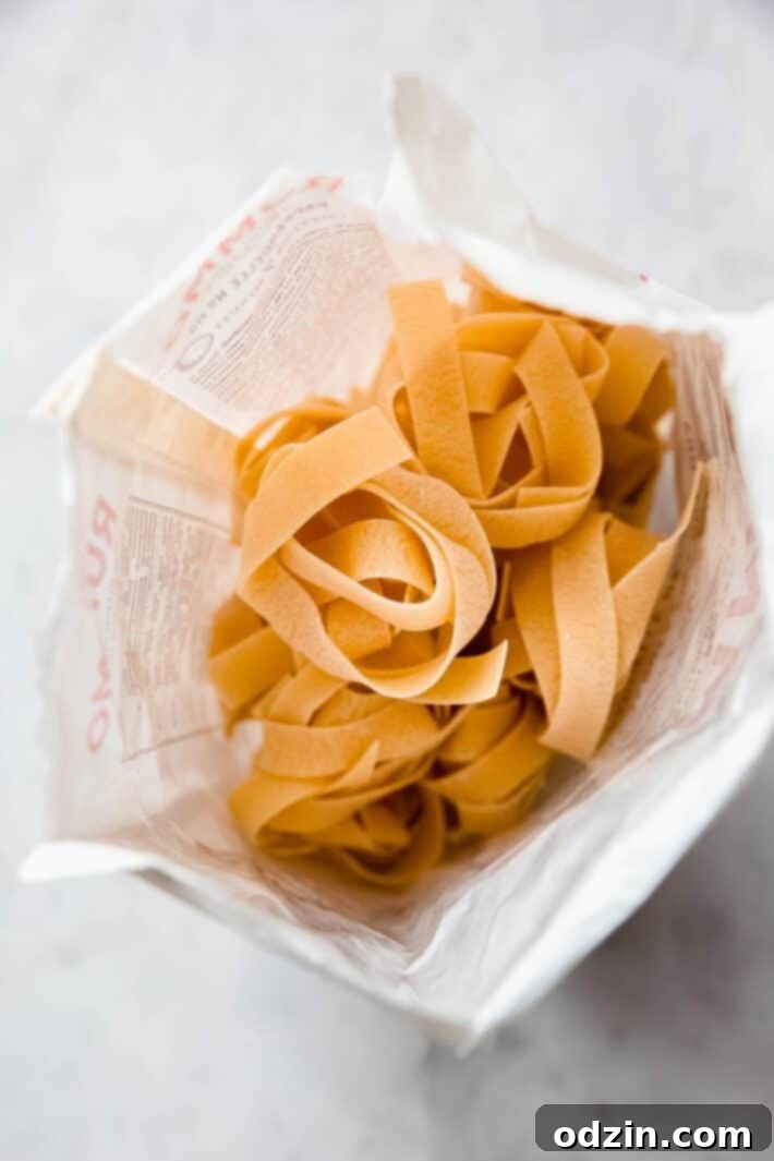 Uncooked dried pappardelle pasta ready to be boiled for the ragu.