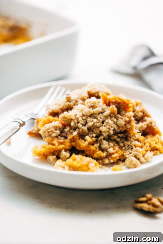 A finished sweet potato casserole, hot out of the oven, sprinkled with sea salt, displaying a perfect golden-brown, crunchy topping.