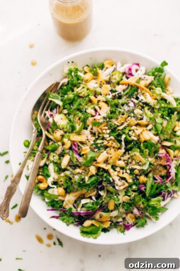 Close-up of a refreshing Asian Kale and Shaved Brussels Sprout Salad with homemade ginger miso dressing