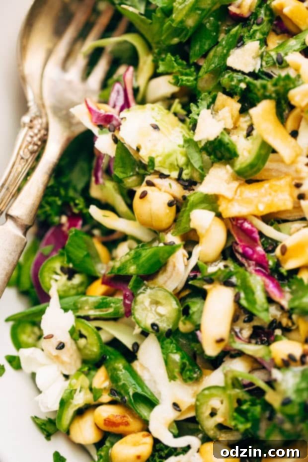 A serving of Asian Kale Shaved Brussels Sprout Salad, highlighting toppings