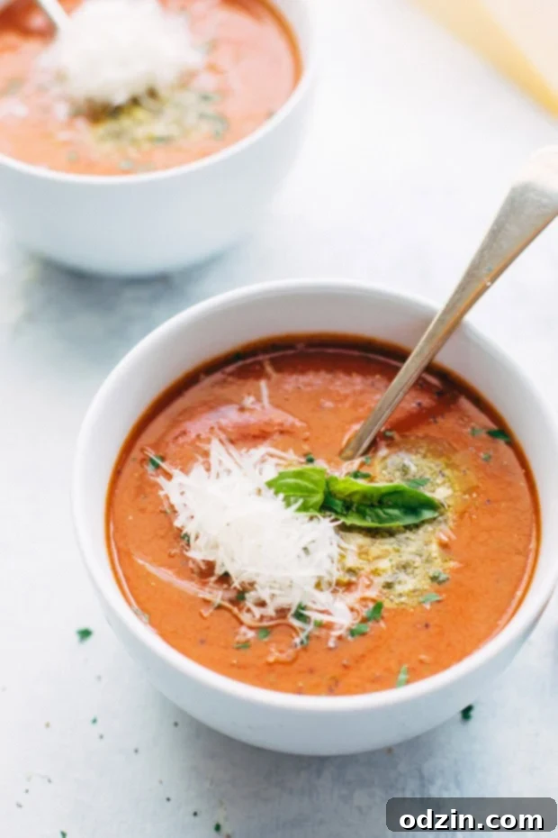 Cozy slow cooker tomato basil soup with Parmesan, an effortless and flavorful dinner idea. #tomatobasilsoup #crockpot #comfortfoodrecipe