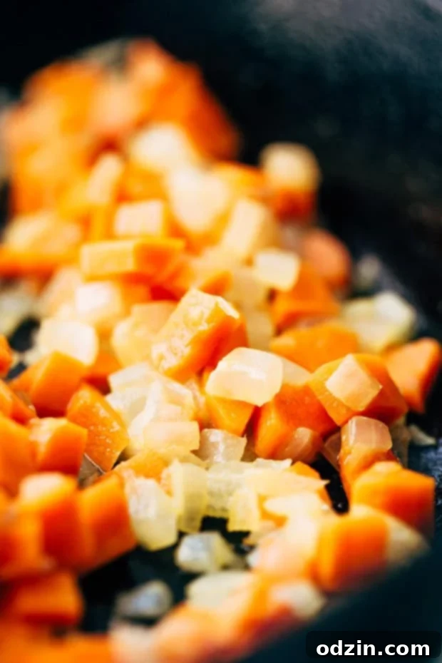 Creamy slow cooker Parmesan basil tomato soup with fresh basil, served in a bowl. #souprecipes #easyrecipes #dinnerideas