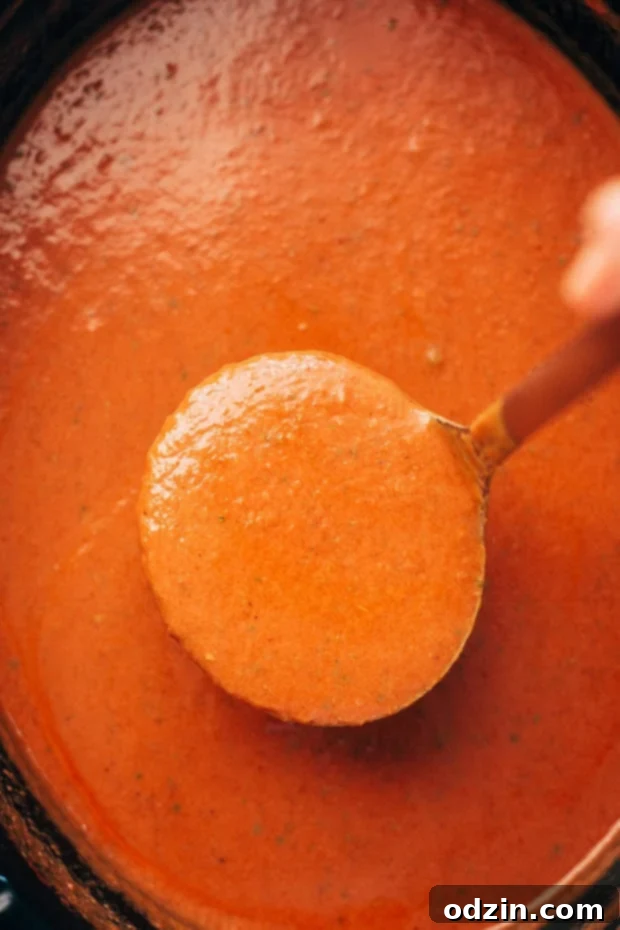 Ingredients for slow cooker Parmesan basil tomato soup laid out on a wooden board. #slowcookerrecipes #tomatobasil #souprecipe