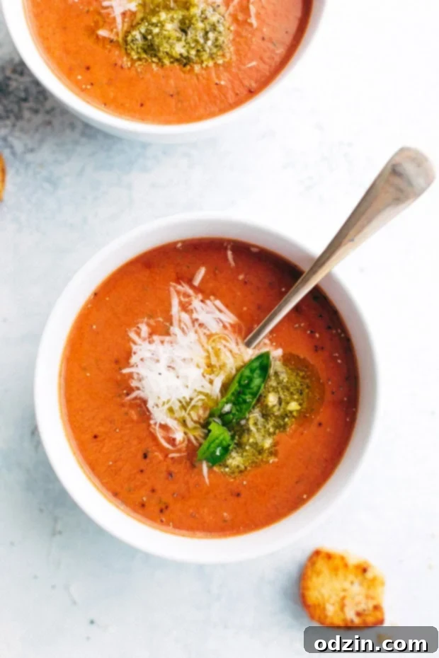 Serving bowls of creamy slow cooker Parmesan basil tomato soup with grilled cheese. #comfortfoodlover #souplover #easycooking